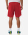 Red men's performance shorts with a loose fit, featuring a logo on the waistband and worn with colourful athletic shoes.