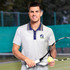 A light grey men's tennis top featuring a multi-striped collar and a logo, worn by a man holding a tennis racquet and ball.