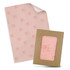 Tissue paper in soft pink with a matching envelope, featuring a logo on the tissue and an open frame design.