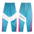 Custom youth active pants in teal with purple and white geometric designs, featuring a logo on one side.