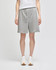 Grey cotton gym shorts with an elastic waistband, featuring a logo and paired with white sneakers.