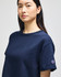 A navy blue cropped short sleeve t-shirt featuring a logo on the sleeve.