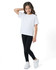 A girl in a white t-shirt and black leggings poses in white sneakers, showcasing the kids' legging design.