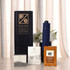 A promotional set including a navy umbrella, two boxes, and a packet, all packaged in a black box with a logo.