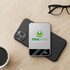 A silver MagSafe wireless power bank resting on a black phone, beside a coffee cup and glasses.