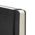 A black 2027 Moleskine planner with a textured cover and elastic band closure, featuring white pages with lined edges.