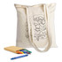 A cream calico tote bag with colouring design, accompanied by crayons and a notebook.