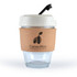 A reusable coffee cup with a clear glass body, a cork band, and a light-colored lid with a straw. It has a logo.