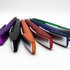 A collection of metallic pens in purple, black, orange, red, blue, and green, featuring a sleek design and branding.