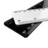 Two plastic rulers, one white and one black, overlapping with measurement markings in both centimetres and inches.