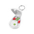 A white pill cutter with a keyring, holding red and green capsules and a green tablet inside.