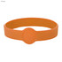 An orange silicone wristband featuring a central circular button and a smooth surface.