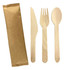 A wooden cutlery set featuring a knife, fork, and spoon, alongside a kraft paper wrapper.