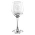A clear glass wine glass with an engraved design on the bowl and a tall, elegant stem.