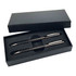 A black gift box contains a carbon pen and pencil set, featuring a sleek design and silver accents.