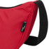 A red waist bag with a black strap and a tag, featuring a textured fabric design.