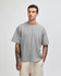 A grey heavyweight cotton unisex boxy t-shirt displayed on a model, featuring a relaxed fit and short sleeves.