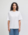 A white unisex heavyweight cotton boxy T-shirt displayed on a model, featuring a simple design and casual fit.