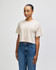 A heavyweight cotton women's crop boxy T-shirt in a neutral beige colour, featuring a relaxed fit and a branding logo.