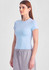 A light blue women's baby tee displayed on a model, featuring a fitted design and short sleeves.