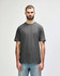 A grey Gildan Softstyle adult midweight T-shirt displayed on a male model, featuring a simple design and a logo.