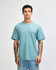 A sueded unisex short sleeve t-shirt in a soft blue colour, featuring a relaxed fit and a visible logo.