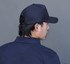 A navy blue cap is depicted, featuring a rear view of a person wearing it. The cap has a branding logo.