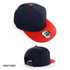 A navy and red cap featuring a flat brim and a logo on the front. The back showcases an adjustable strap.
