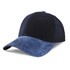 A navy cap featuring a suede peak, with a smooth fabric crown and a logo on the front.
