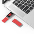 A red Milan LED flash drive is connected to a laptop, with another red flash drive nearby. The product features a logo.