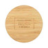 A round bamboo wireless charger with a smooth surface and a hidden logo on the bottom.