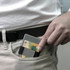 A silver RFID wallet is partially placed in a pocket, featuring a dark strap.