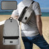 A grey convertible bum bag is worn over the shoulder, with a backpack resting on the person’s back by the beach.