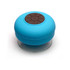 A round, blue waterproof Bluetooth speaker with a control panel on top, featuring a clear bottom.