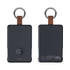 A black magnetic power bank with a leather strap and keyring, featuring a circular charging area and indicator lights.