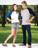 A woman in a white and blue 3/4 sleeve raglan T-shirt and a man in a grey T-shirt with navy sleeves stand outdoors.
