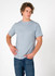 A men's slim fit t-shirt in light blue, featuring short sleeves and a round neckline, paired with blue jeans.
