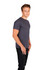 A man poses in a grey men's slim fit T-shirt, paired with black jeans, against a plain white background.