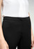 Black women's slacks feature a sleek design, shown with a light-coloured shirt. The waistband is smooth and tailored.
