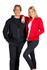 Two people wearing men's zip hoodies, one in black and the other in red, both featuring pockets.