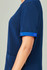 Unisex scrub top in navy with blue accents on the rolled sleeves, featuring a pocket on the side.