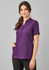 A women's tunic in a rich purple colour with short sleeves and pockets, featuring a button-up placket and a logo.