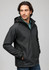 A black soft shell jacket with a hood, featuring a zip front and side pockets, worn by a male model.