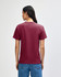 A heavyweight unisex t-shirt in burgundy, featuring a simple design and a visible logo on the back.