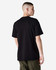 A black heavyweight cotton unisex T-shirt displayed on a model from the back, featuring a simple design and loose fit.