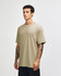 A heavyweight cotton unisex t-shirt in a light beige colour, featuring a crew neck and short sleeves.