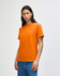An orange heavyweight cotton unisex T-shirt on a model, paired with light blue jeans.