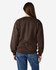 A brown Gildan Heavy Blend adult crewneck sweatshirt, viewed from the back, paired with blue jeans.