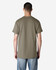 A male model wearing a green Gildan Ultra Cotton adult t-shirt, viewed from the back. Casual fit and short sleeves.