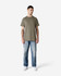 A model stands wearing a plain olive green Gildan Ultra Cotton adult T-shirt paired with light blue jeans.